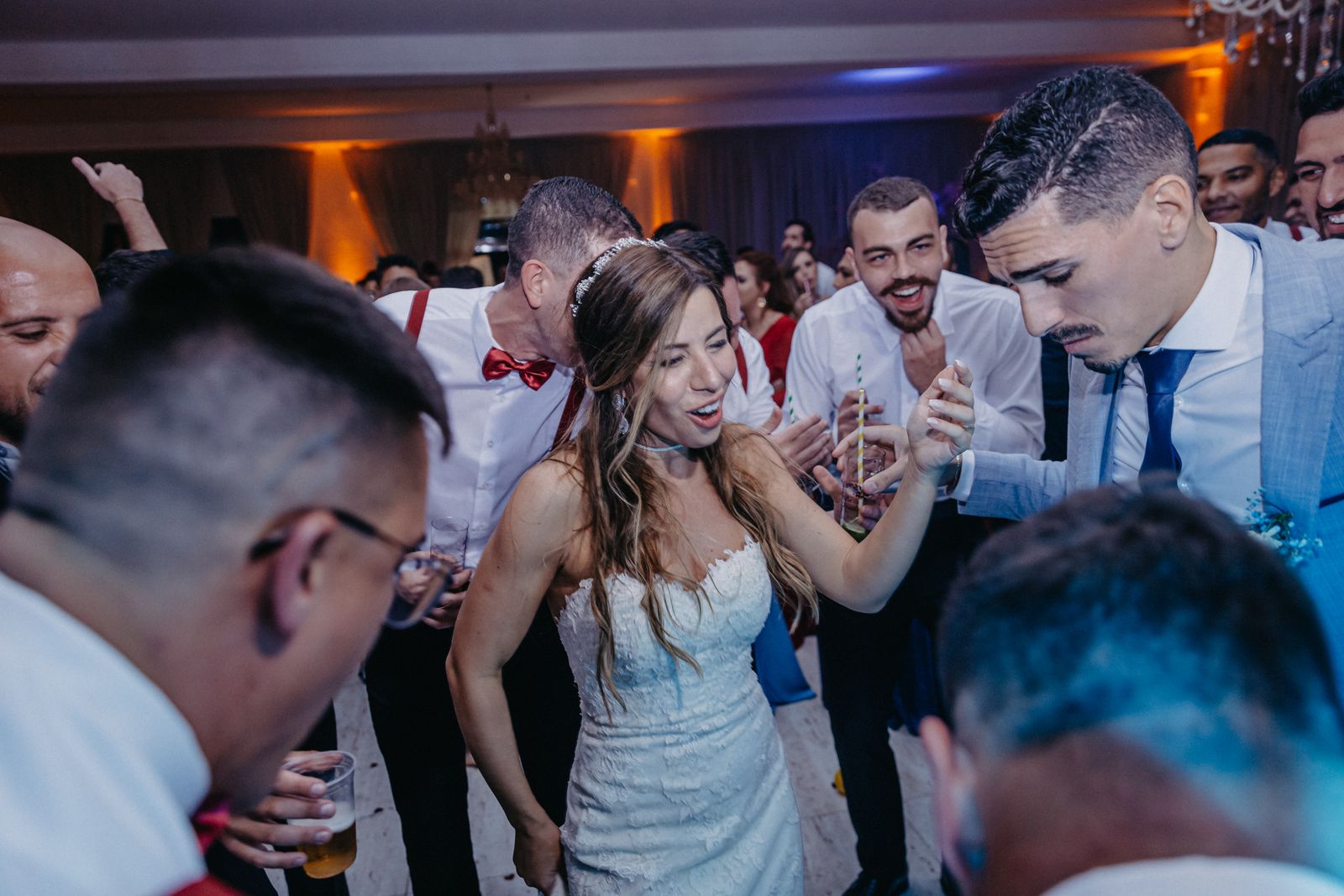 A photographer capturing guests celebrating on a wedding dance floor